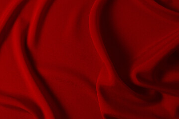 Red silk or satin luxury fabric texture can use as abstract background. Top view.