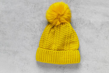 Yellow cap on a gray concrete background. Luminous yellow and extremely gray. The color of 2021. Copy space