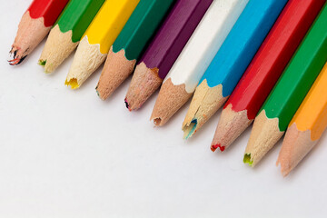 Set of old used and broken colored pencils on a white background. Ugly worn crayons or pencils with broken ends should be sharpened. Creativity, broken things or kids concept.