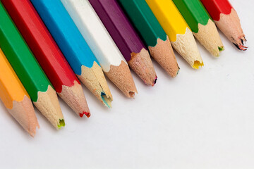 Set of old used and broken colored pencils on a white background. Ugly worn crayons or pencils with broken ends should be sharpened. Creativity, broken things or kids concept.