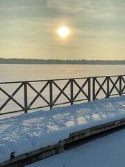 View of the frozen Białe Lake near Włodawa with wooden decks a lot of snow just before sunset golden hour
