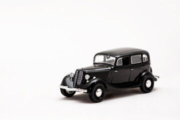  Miniature model of a retro car on a white background. A toy car model. Vintage car model.