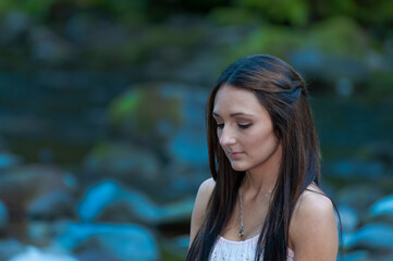 Young Woman Poses Along the Banks of a River