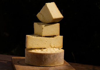 Piled English Chesire cheese still life with a black background