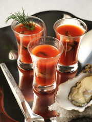three of bloody mary shots served with oyster  © artemfaust