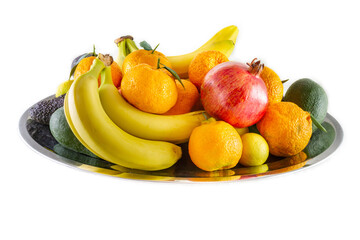 Assorted fruit and vegetable platter of bananas, pomegranate, lemon, tangerine and avocado.