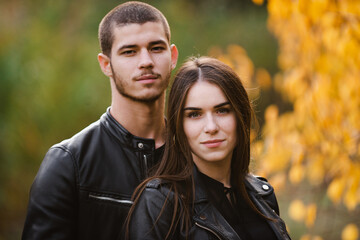 Fototapeta premium The guy with the girl lovers walk in the park autumn