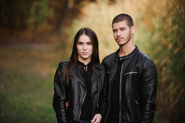 Fototapeta premium The guy with the girl lovers walk in the park autumn