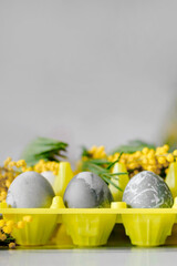 Happy Easter. Marble Eggs Mimosa on the Kitchen Table. Design and traditional decoration for the Holiday.