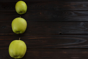 green apples on wooden background