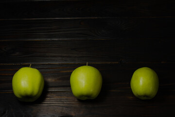 green apples on a wooden table