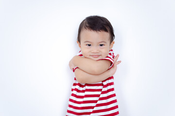 Portrait of Asian baby boy smiling with crossed arms on white background, Confident and cheerful kids concept.