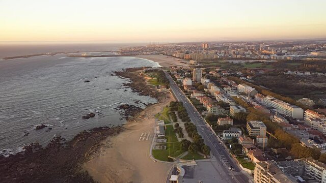 Aerial view of Porto city, Portugal, Europe. Drone flying over houses located at coastline of atlantic ocean. Panoramic cityscape of Porto at sunset. 4k footage in hyper lapse