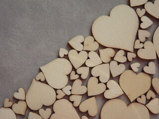 Fototapeta premium valentine's day greeting card-wooden hearts on a gray suede background. High quality photo