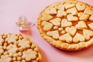 Delicious fragrant pies on a pink background.