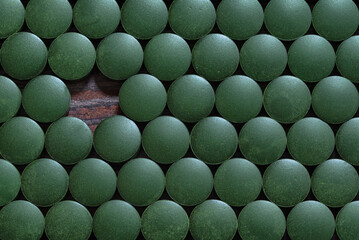 Pile of spirulina tablets background