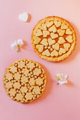 Delicious fragrant pies on a pink background.