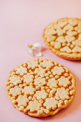Delicious fragrant pies on a pink background.