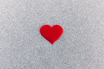 Red heart on a grey sparkle background. Minimal concept for Valentine day.