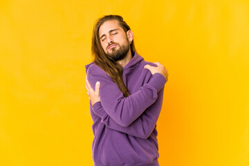 Young man with long hair look hugs, smiling carefree and happy.