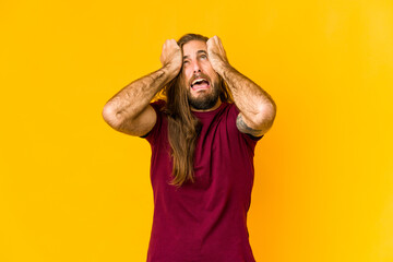 Young man with long hair look crying, unhappy with something, agony and confusion concept.