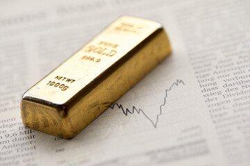 Gold bullion  on the graph as crisis safe haven, financial asset, investment and wealth concept...