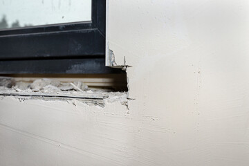Forged place in the wall under the window, prepared for installing a window sill inside the house.