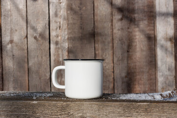 White cup on the wooden background. Minimalistic natural design.