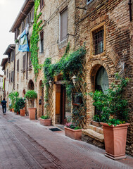 Fototapeta na wymiar Old street in San Gimignano, Tuscany, Italy. San Gimignano is typical Tuscan medieval town in Italy