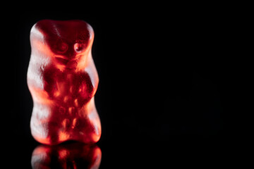 Sweet gummy bears on black background