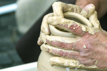 Potter's hands . ceramic ware of clay. pottery