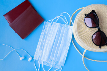 Documents, sunglasses, headphones on a bright background. vacation and rest after the pandemic.