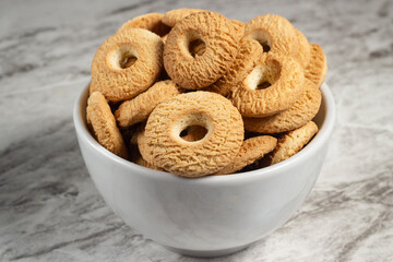 Ring Coconut biscuits served on a bowl. Brazilian little donut. Seletive focus.