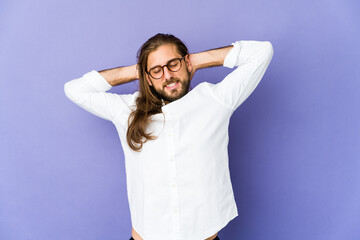 Young man with long hair look feeling confident, with hands behind the head.