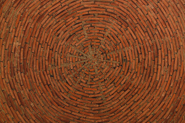 Brick ceiling of red color forming circles. Vintage background.