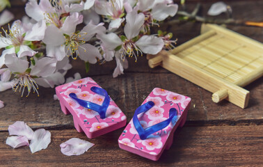 Almond Flowers and Japanese Sandals On Wood