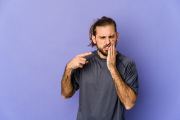 Young man with long hair look having a strong teeth pain, molar ache.