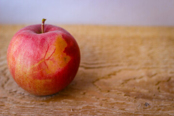Red apple stand on a wooden surface