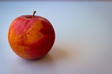 Red apple stand on a white surface
