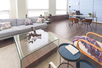 Modern trendy creative design of a personal studio office with a seating area in the style of minimalism in blue and beige colors with large windows and daylight