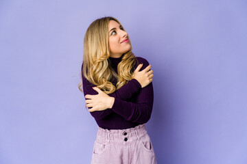 Fototapeta premium Young caucasian blonde woman hugs, smiling carefree and happy.