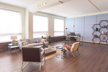 Modern trendy creative design of a personal studio office with a seating area in the style of minimalism in blue and beige colors with large windows and daylight