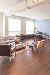 Modern trendy creative design of a personal studio office with a seating area in the style of minimalism in blue and beige colors with large windows and daylight