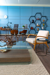 Modern trendy creative design of a personal studio office with a seating area in the style of minimalism in blue and beige colors with large windows and daylight