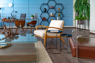 Modern trendy creative design of a personal studio office with a seating area in the style of minimalism in blue and beige colors with large windows and daylight