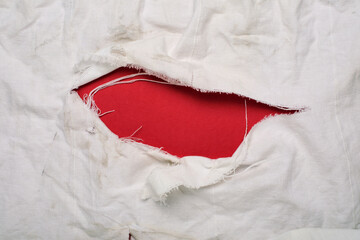 Texture of an old dirty ragged cloth with copy space, white fabric with big hole and shredded...