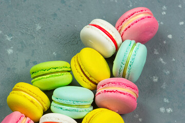 Bright pastries macarons on a gray background.