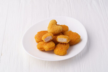 Chicken nuggets on a white plate