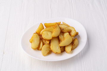 Rustic fried potatoes on a white plate