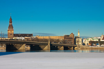 Fototapeta premium riga. in the photo, a panorama of the city and a stone bridge against the blue sky